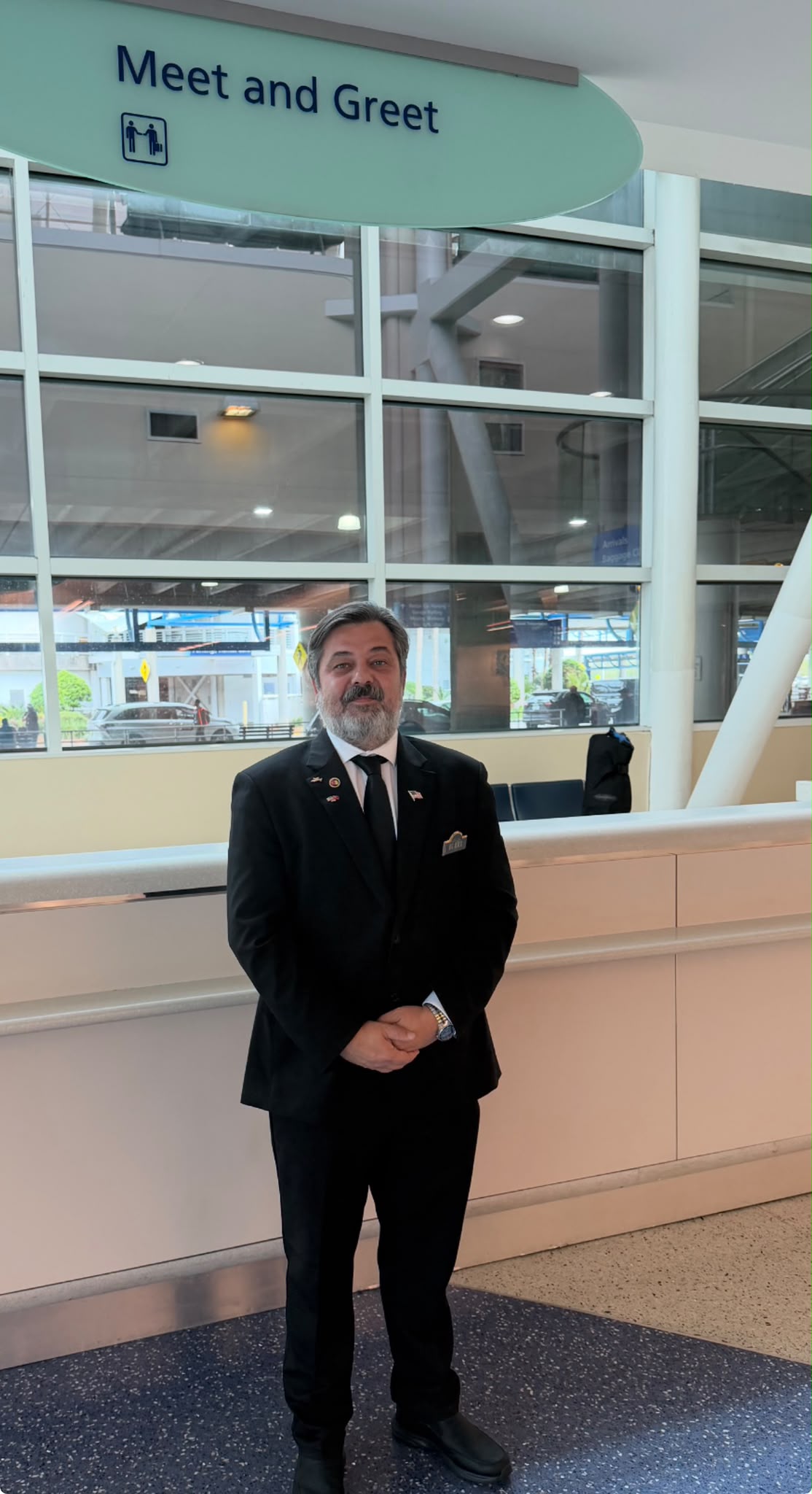 Chauffeur meeting passengers at baggage claim in Jacksonville airport